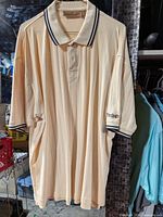Full front view of beige Firethorn polo hanging
