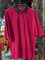 Front view of red and black striped polo shirt on hanger