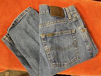 Folded jeans showing back pocket and leather Lee patch