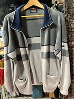 Front view of knit zip jacket showing color pattern, pockets and collar