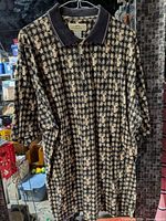 Full view of polo shirt front on hanger