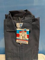 Front view folded navy coveralls with Big Bill hangtag