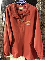 Front view of maroon quarter-zip pullover jacket