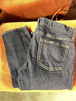 Front view of folded dark indigo jeans highlighting overall appearance