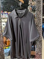 Front view of black OnTour polo shirt hanging