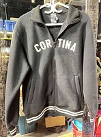 Front view of black Roots Cortina fleece jacket on hanger