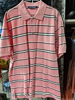 Front of pink striped polo shirt hanging