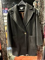 Front view of black Topshop coat on hanger