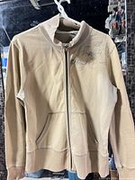 Full front view of beige zip jacket showing overall style