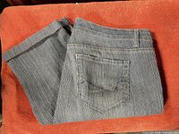 Pants folded showing back pocket and pinstripe pattern