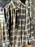 Front view of Viyella plaid flannel shirt hanging