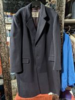 Full view of dark navy wool-cashmere overcoat on hanger