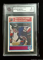 Front of slabbed Mike Bossy Record Breaker card showing grade label 8 NMM