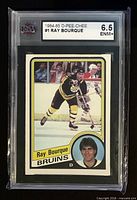 Front of slabbed Ray Bourque 1984-85 O-Pee-Chee #1 card showing grade label 6.5 ENM+