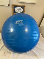 Full view of blue Body Sculpture exercise ball on table