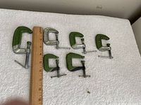 Six C-clamps with ruler for scale