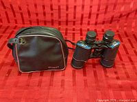 Celebrity binoculars alongside original carrying case