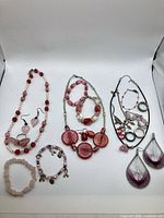 Full group of necklaces, bracelets, earrings, rings on white background