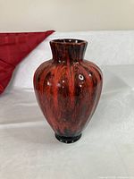 Front view of red and black Evangeline Pottery vase