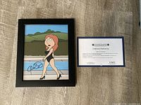 Framed signed photo and certificate of authenticity displayed side by side