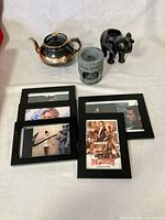 Group shot showing teapot, oil burner, elephant candle holder, five photo frames