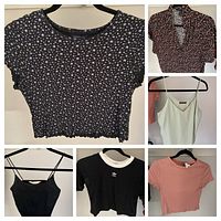 All six women’s tops hung on hangers, showing front view and styles