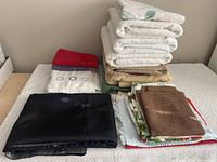 Full lot showing bath towels, shower curtain, dish towels
