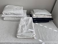 Overall view showing stacks of white, floral and dark sheets and pillowcases