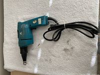 Full view of Makita drywall screw gun with cord