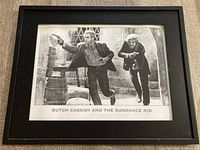 Front view of framed photograph showing image, caption and frame
