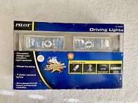Front of box showing Pilot brand, Driving Lights label, two lamps visible through window