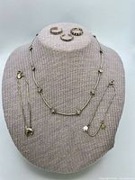 Entire lot displayed on bust: necklace, three rings, two bracelets