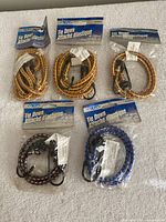 Front view of five sealed packages of braided elastic tie-down bungee cords
