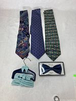 Full lot view: three neckties, boxed bow tie, tie hanger