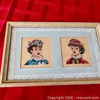 full view of framed petit point showing both portraits