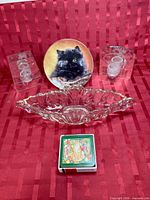 All items grouped: cat plate, two glass candle holders, clear glass bowl, coaster box