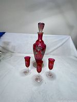 Full view of decanter with stopper and three glasses