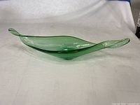 Full view of green blown glass bowl side profile