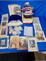 Overview of fabric pieces, lace trims and multiple sewing patterns