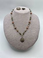 Full view necklace on bust with two rings displayed