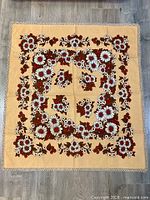 Full view of square tablecloth showing entire floral pattern and tatting lace border