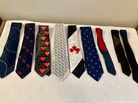 Nine assorted ties laid flat showing full patterns