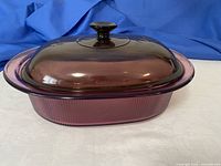 Cranberry tinted oval Visions glass casserole with lid