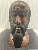 Front view of entire wooden bust showing overall form