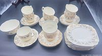 Overall view of bowl, cups, saucers, plates