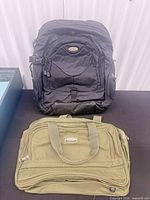 Front view of black backpack and olive Samboro briefcase