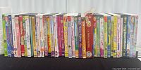 Full row of approximately 29 DVD cases on tabletop
