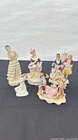 Group view of all six porcelain figurines