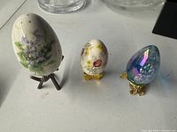 Three decorative eggs each on its own stand