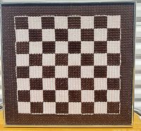 Full view of framed checkerboard textile art